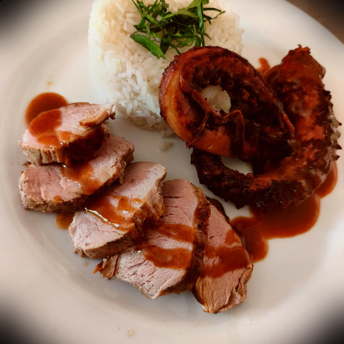 Sliced pork tenderloin with grilled octopus and rice