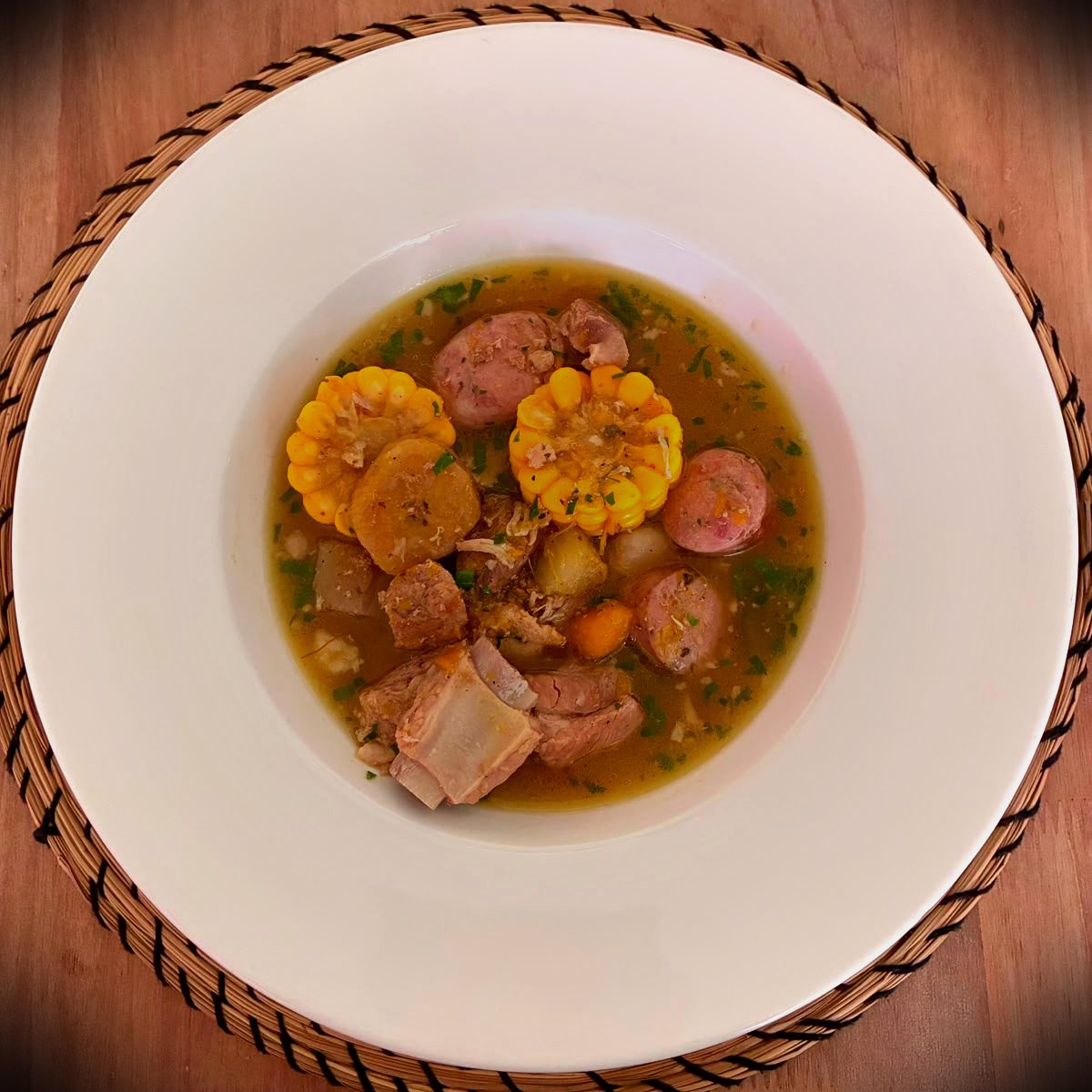 Traditional Dominican sancocho stew with corn and root vegetables