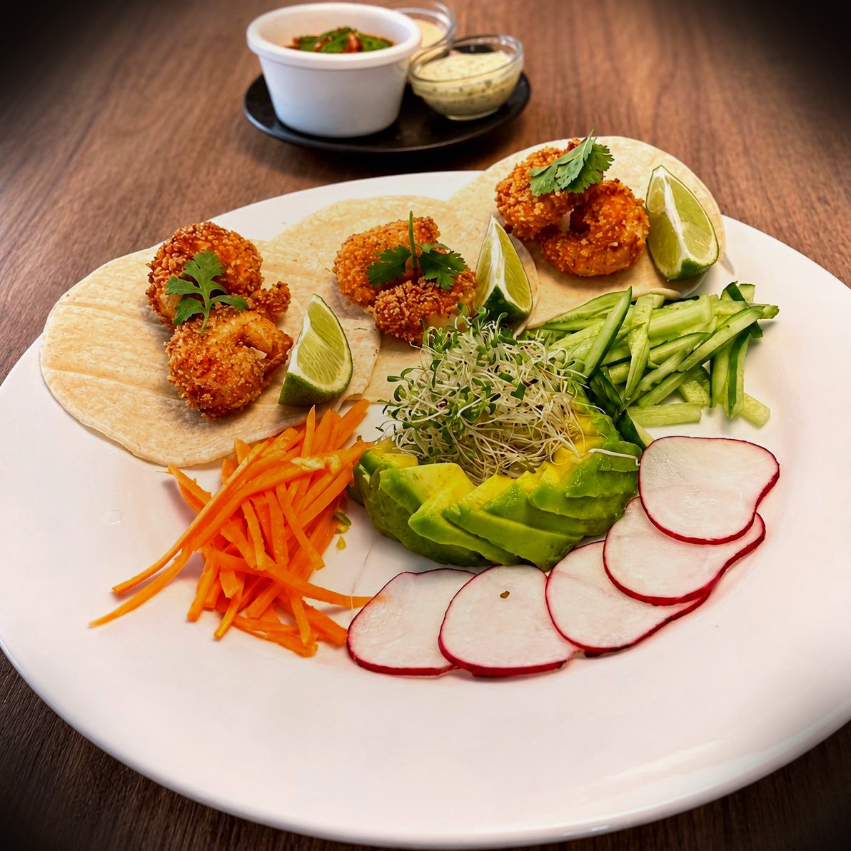 Crispy coconut shrimp tacos with avocado, radish, and lime