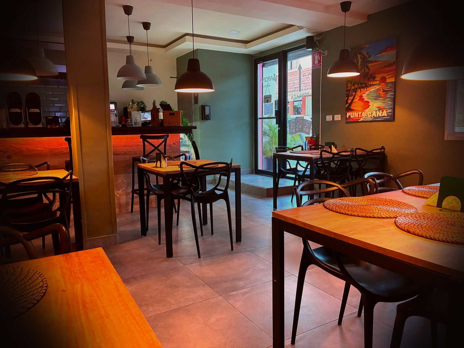 Aroma dining room with sage green walls and warm lighting